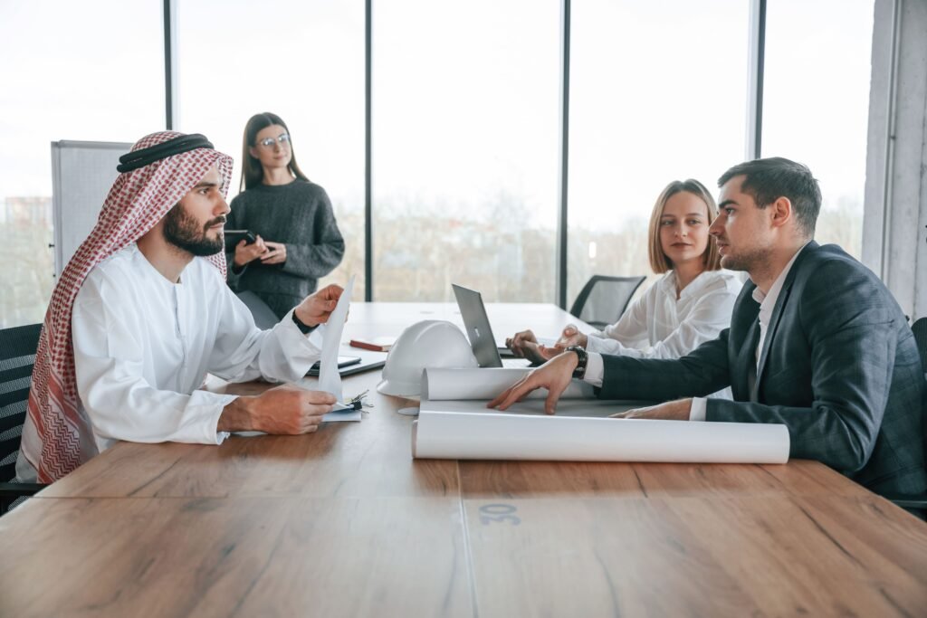 conception teamwork muslim businessman traditional outfit with colleagues office